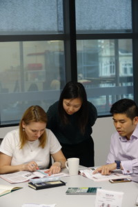 Chinese teacher helping her students A teacher is checking her students' process in Chinese learning
