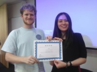 Learning Chinese is rewarding (full) A student is receiving his certificate from his teacher