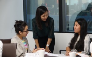 Teacher teaching two students Teacher supporting her students in Chinese learning