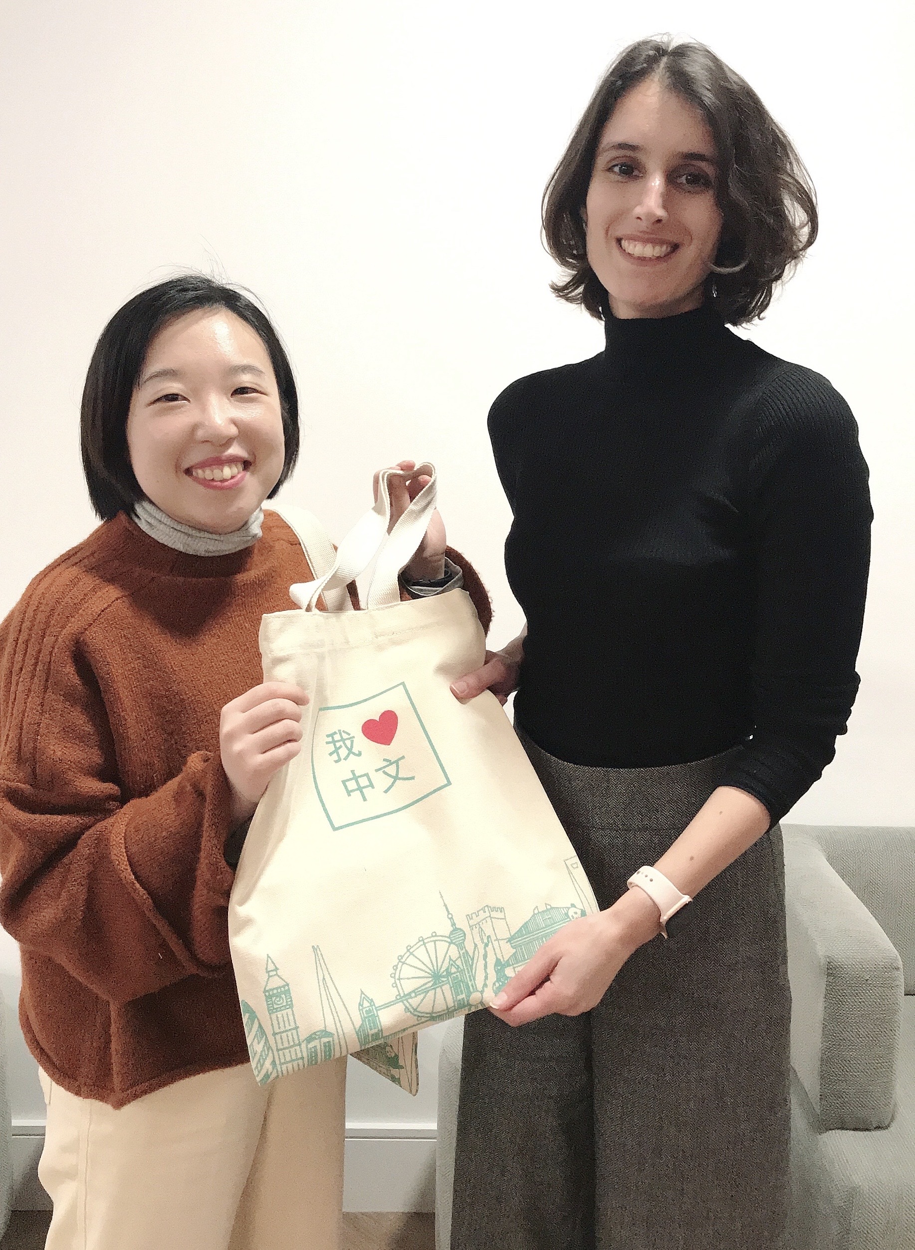 a teacher and a student with Practical Mandarin's tote bag